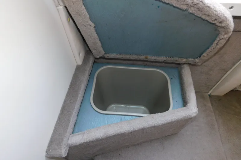 Slide: The Image of Storage compartment on a 1996 Sea Ray 250 Sundancer boat, featuring a built-in cooler. - 66