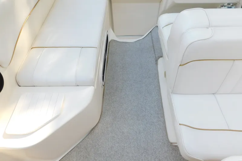 Slide: The Image of Interior seating of a 1996 Sea Ray 250 Sundancer boat with white upholstery. - 41