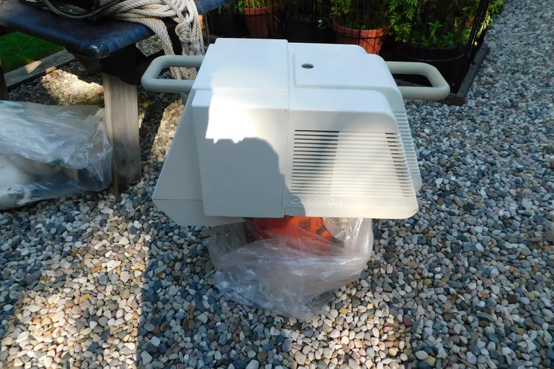 Slide: The Image of Portable generator on gravel, near a Sea Ray 250 Sundancer boat, 1996 model. - 90