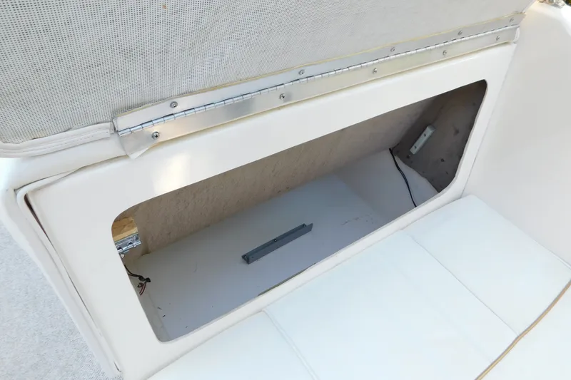 Slide: The Image of Storage compartment in a 1996 Sea Ray 250 Sundancer boat, featuring white interior. - 78