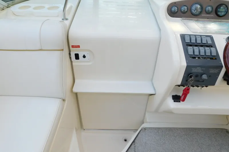 Slide: The Image of 1996 Sea Ray 250 Sundancer cockpit with control panel and seating area. - 45