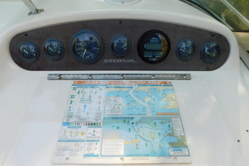 Slide: The Image of Dashboard of a 1996 Sea Ray 250 Sundancer with navigation rules chart. - 36
