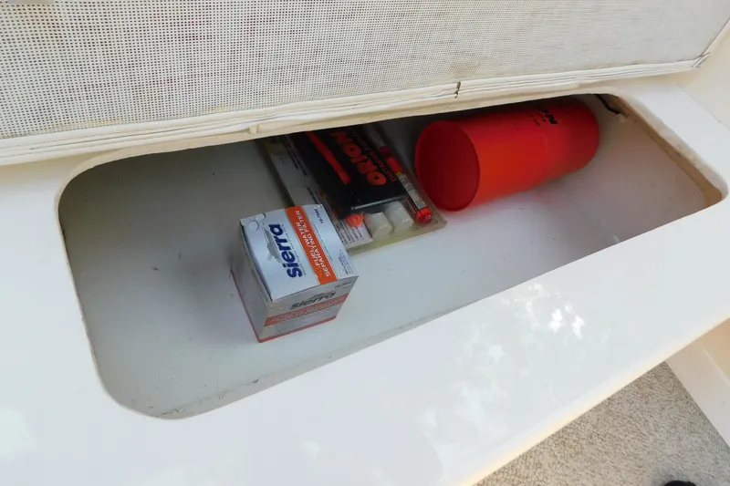 Slide: The Image of Storage compartment in a 1996 Sea Ray 250 Sundancer with boating essentials. - 79