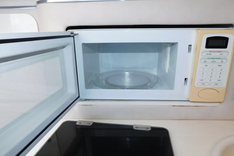 Slide: The Image of Open microwave in 1996 Sea Ray 250 Sundancer boat kitchen area. - 56