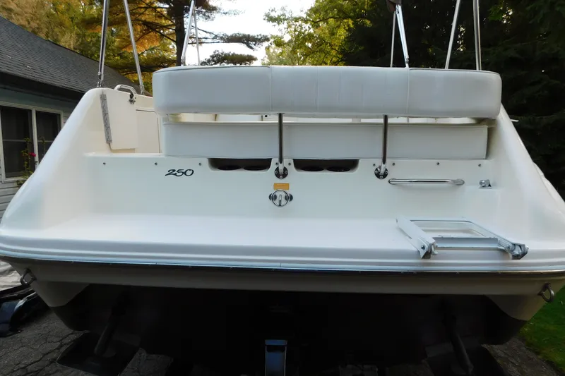 Slide: The Image of 1996 Sea Ray 250 Sundancer boat stern view with swim platform and ladder. - 15