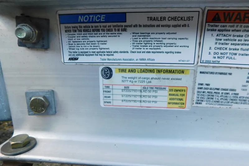 Slide: The Image of Trailer checklist and tire information labels on a 1996 Sea Ray 250 Sundancer. - 20