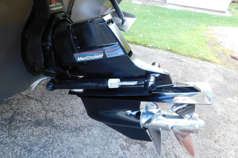 Slide: The Image of MerCruiser Bravo Three outdrive on 1996 Sea Ray 250 Sundancer boat, parked on pavement. - 11