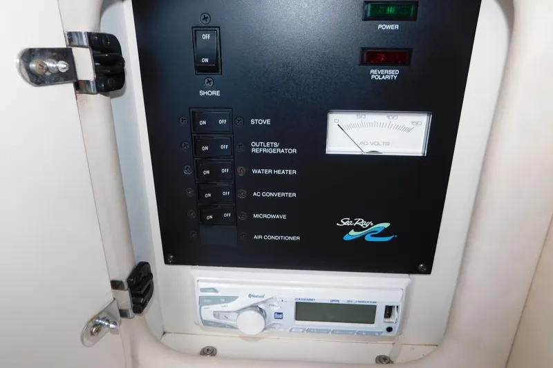 Slide: The Image of Electrical control panel of 1996 Sea Ray 250 Sundancer boat with various switches and voltmeter. - 59