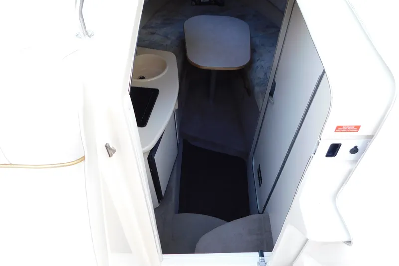 Slide: The Image of Interior view of a 1996 Sea Ray 250 Sundancer cabin with kitchenette and seating area. - 47