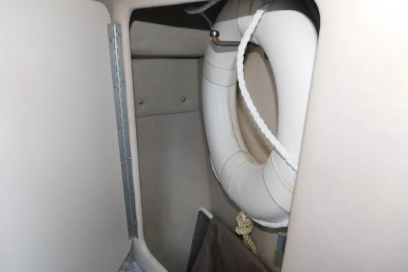 Slide: The Image of Interior storage of 1996 Sea Ray 250 Sundancer with life preserver. - 53