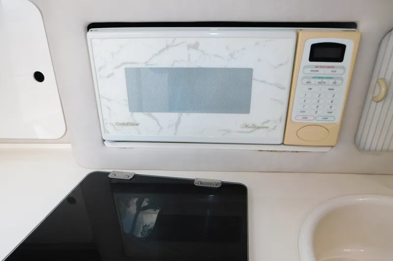 Slide: The Image of Microwave and stove in 1996 Sea Ray 250 Sundancer boat kitchen area. - 55