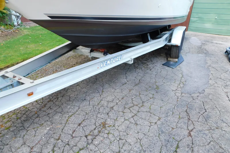 Slide: The Image of 1996 Sea Ray 250 Sundancer on Venture trailer, parked on cracked pavement. - 21
