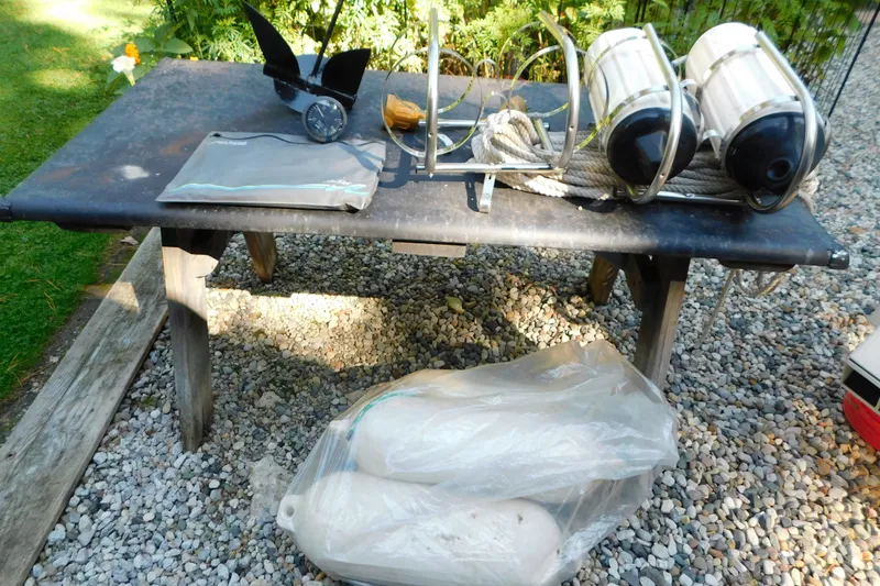 Slide: The Image of Boat accessories on table, including propeller and fenders, for 1996 Sea Ray 250 Sundancer. - 97