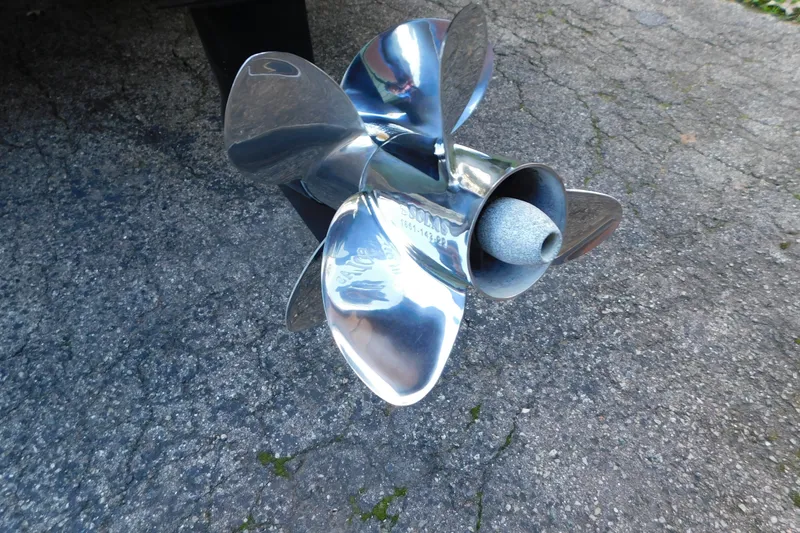 Slide: The Image of Shiny propeller of a 1996 Sea Ray 250 Sundancer on concrete surface. - 12