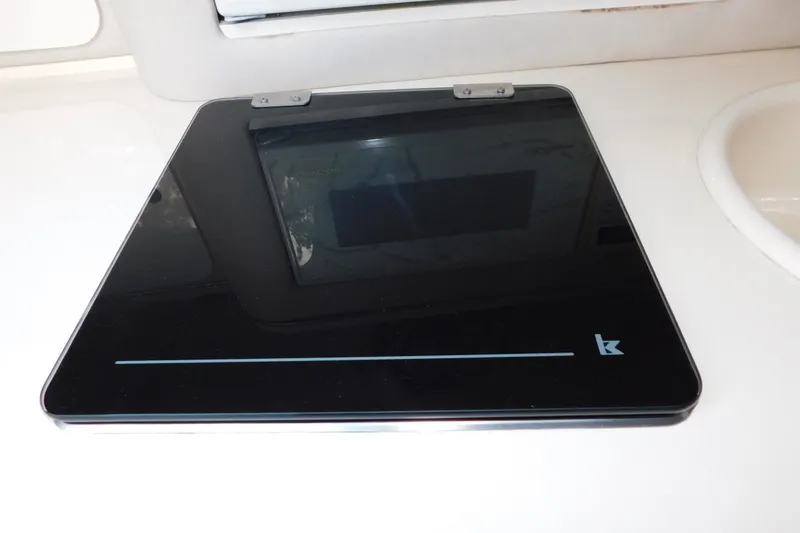 Slide: The Image of Black induction cooktop on 1996 Sea Ray 250 Sundancer yacht kitchen counter. - 57