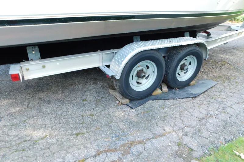 Slide: The Image of Trailer for 1996 Sea Ray 250 Sundancer boat, parked on cracked pavement. - 16