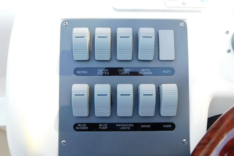 Slide: The Image of Control panel of a 1996 Sea Ray 250 Sundancer boat with labeled switches. - 37