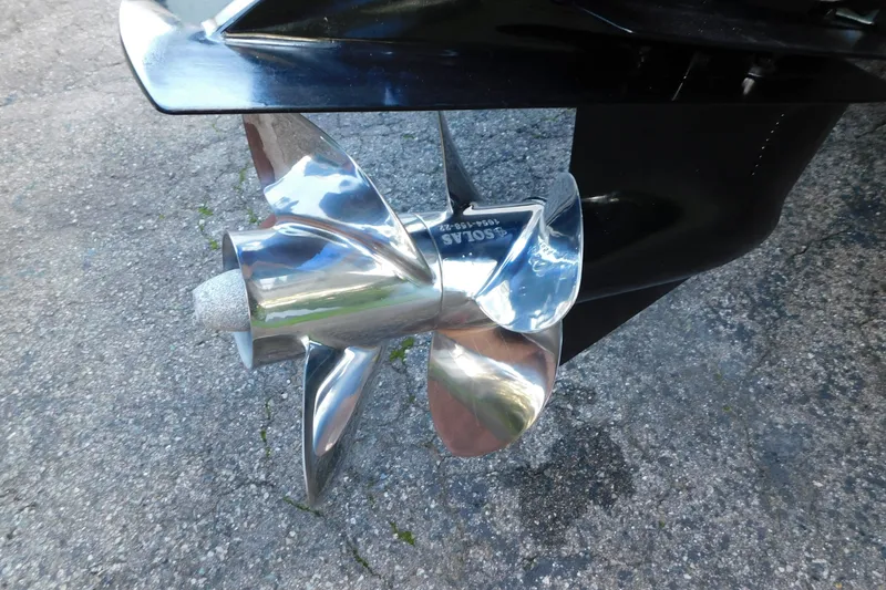 Slide: The Image of Shiny propeller of a 1996 Sea Ray 250 Sundancer boat on pavement. - 14