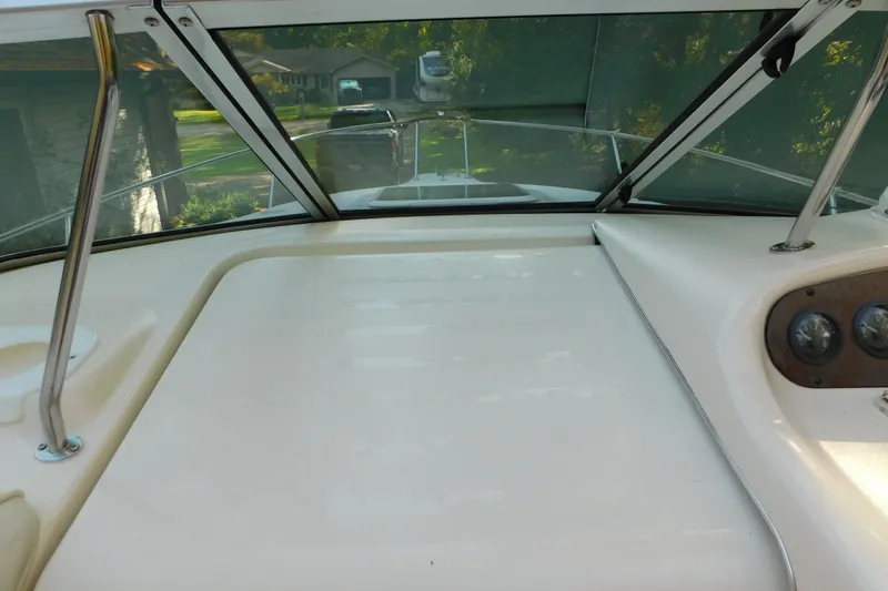 Slide: The Image of 1996 Sea Ray 250 Sundancer boat interior with windshield and dashboard view. - 44