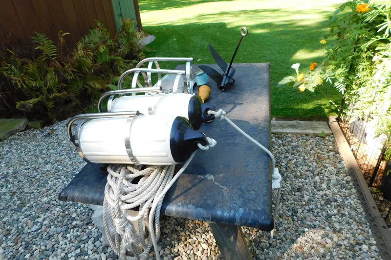 Slide: The Image of Boat accessories on table, including fenders and anchor, for 1996 Sea Ray 250 Sundancer. - 93