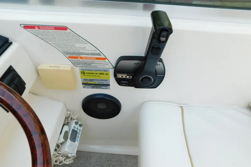 Slide: The Image of 1996 Sea Ray 250 Sundancer boat controls and capacity warning label. - 34