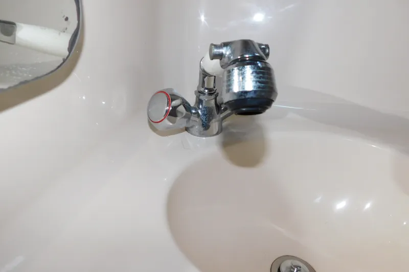 Slide: The Image of Chrome faucet in a 1996 Sea Ray 250 Sundancer boat bathroom sink. - 73