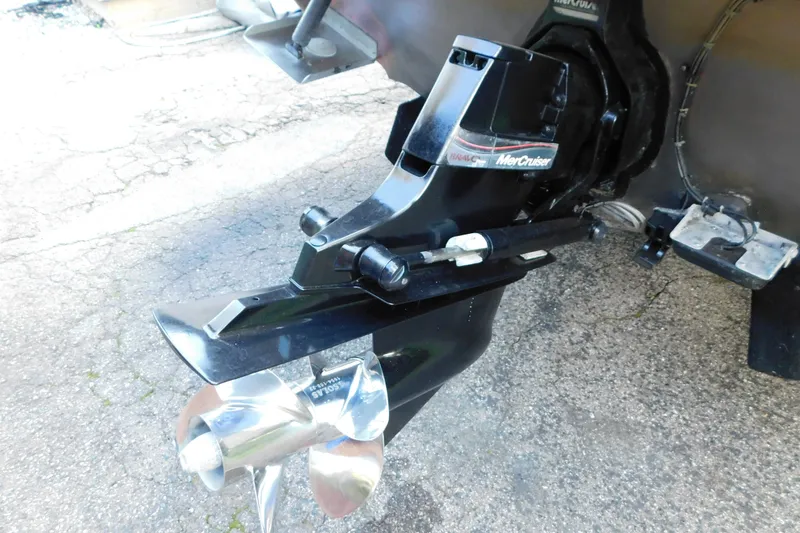 Slide: The Image of MerCruiser outdrive on a 1996 Sea Ray 250 Sundancer boat, showing propeller detail. - 13