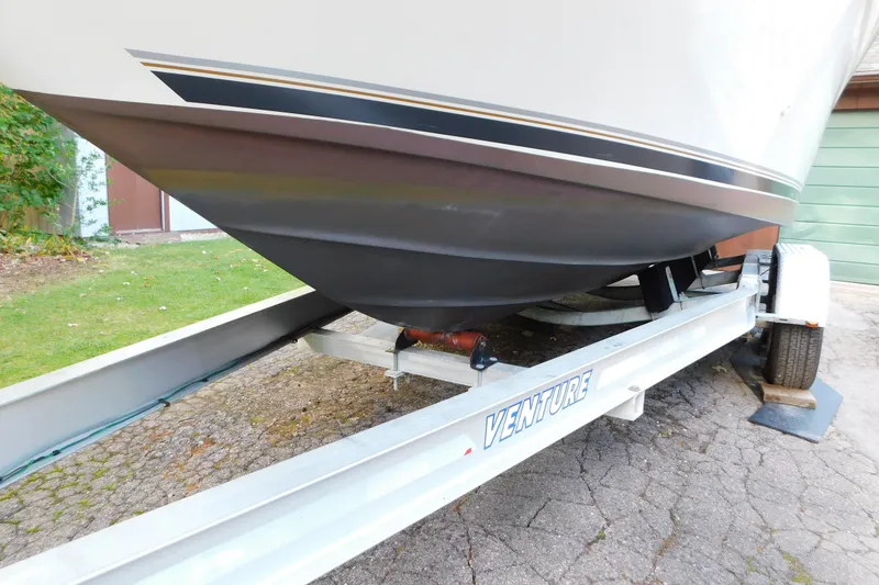 Slide: The Image of 1996 Sea Ray 250 Sundancer boat on Venture trailer, parked on driveway. - 6