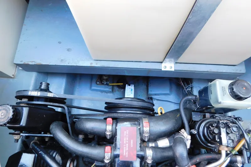 Slide: The Image of Engine compartment of a 1996 Sea Ray 250 Sundancer boat, showcasing mechanical components. - 88