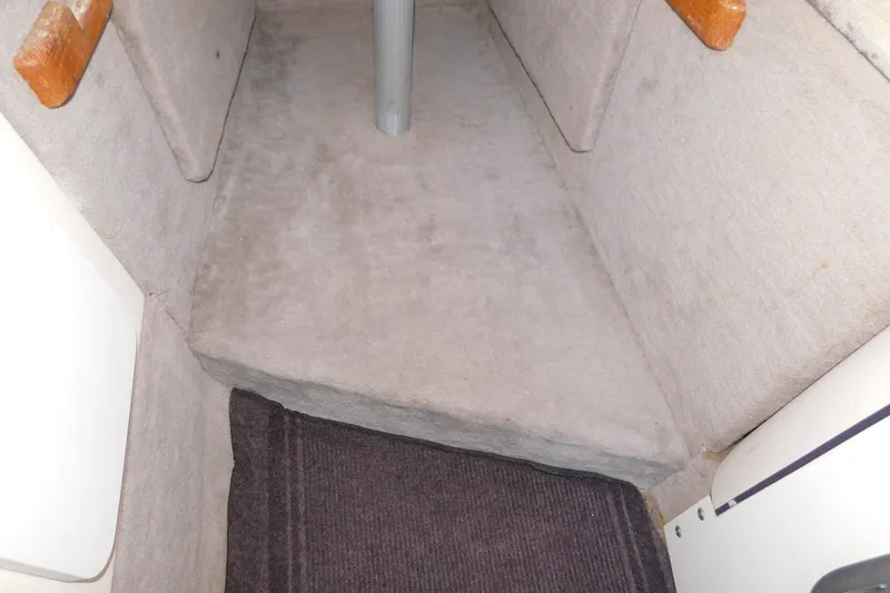 Slide: The Image of Interior cabin of a 1996 Sea Ray 250 Sundancer boat, featuring carpeted flooring. - 67