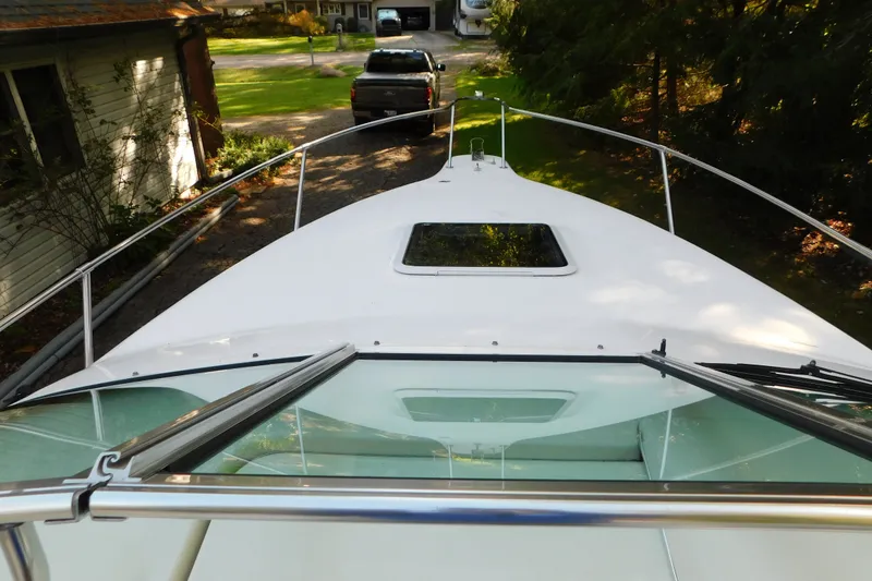 Slide: The Image of 1996 Sea Ray 250 Sundancer boat deck view with windshield and railing. - 43