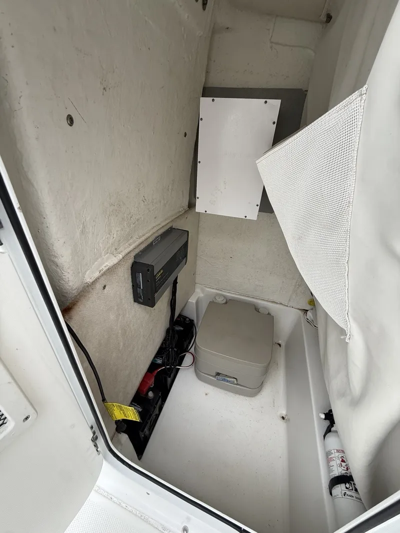 Slide: The Image of Interior of a 2018 Sea Hunt BX25BR with electronics and a portable toilet. - 14