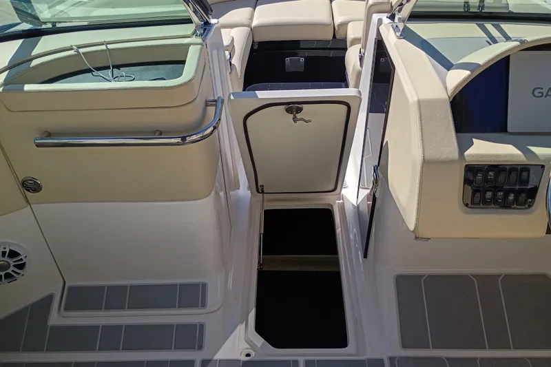 Slide: The Image of 2021 Regal 29 OBX boat interior with open storage compartment and seating area. - 26