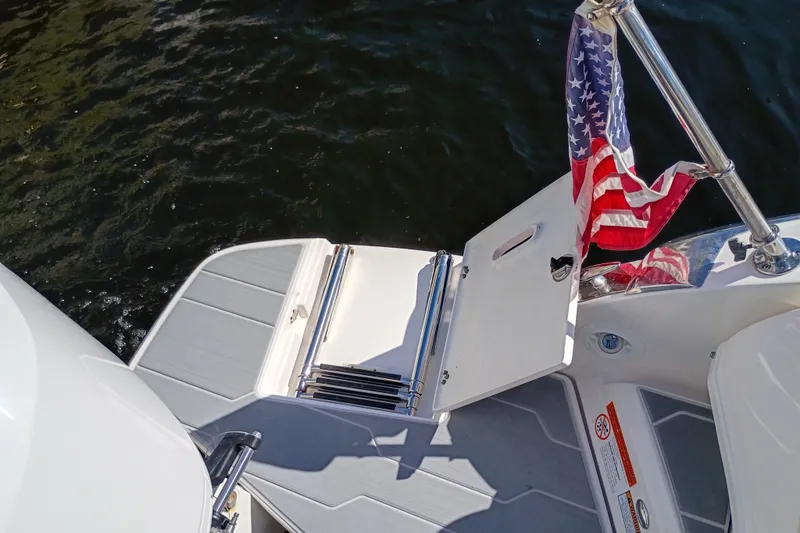 Slide: The Image of 2021 Regal 29 OBX boat swim platform with American flag and ladder. - 36