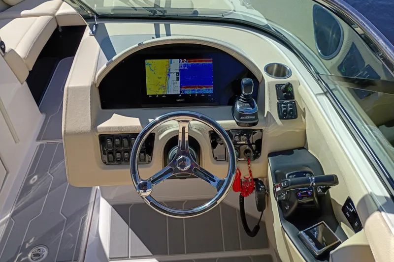 Slide: The Image of 2021 Regal 29 OBX boat dashboard with steering wheel and navigation display. - 13