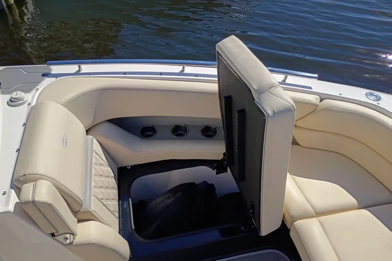 Slide: The Image of 2021 Regal 29 OBX boat interior with beige seating and cup holders. - 20
