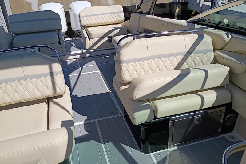 Slide: The Image of Luxurious seating on a 2021 Regal 29 OBX boat, featuring elegant beige upholstery. - 25