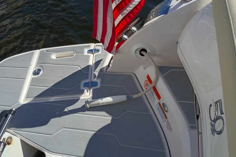 Slide: The Image of 2021 Regal 29 OBX boat deck with American flag and water hose. - 35