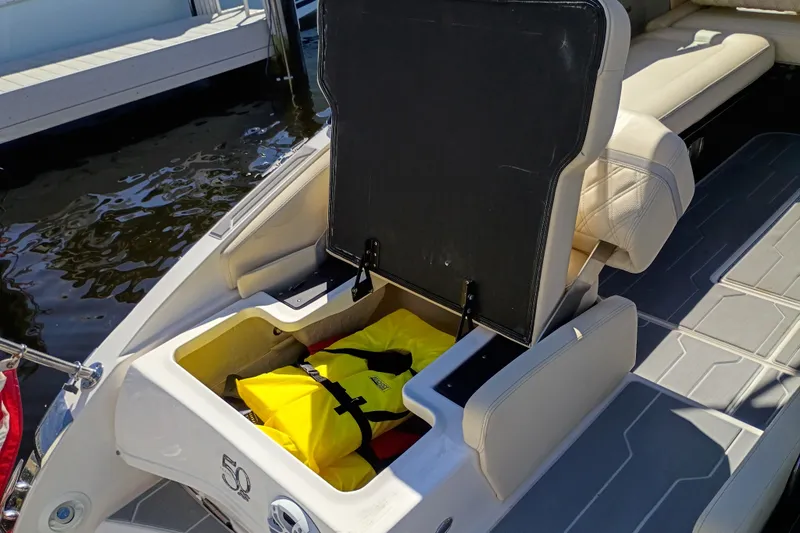 Slide: The Image of 2021 Regal 29 OBX boat with open storage compartment containing a yellow life jacket. - 39