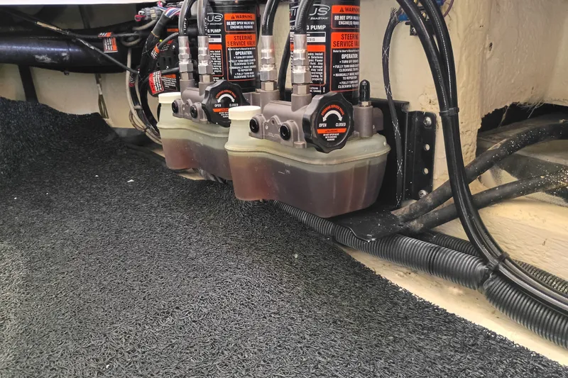 Slide: The Image of Hydraulic steering system in a 2021 Regal 29 OBX boat, featuring dual pumps and wiring. - 33