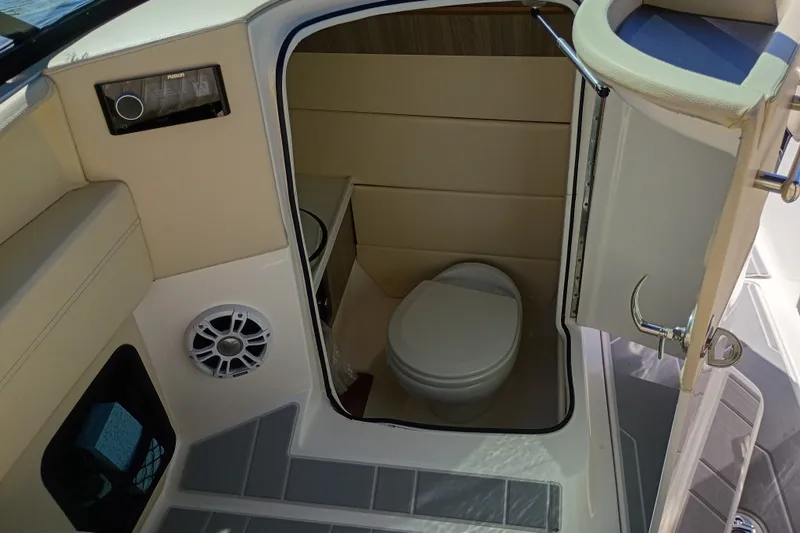 Slide: The Image of 2021 Regal 29 OBX boat interior with compact bathroom and modern amenities. - 45