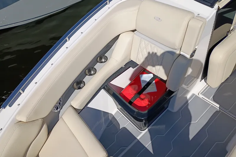 Slide: The Image of Luxurious seating on 2021 Regal 29 OBX boat with cup holders and storage compartment. - 21