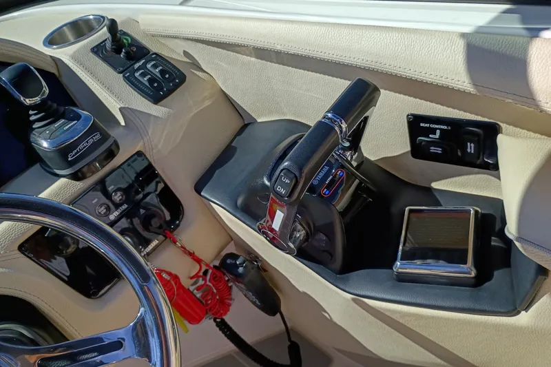 Slide: The Image of 2021 Regal 29 OBX boat cockpit with steering wheel and control panel. - 15