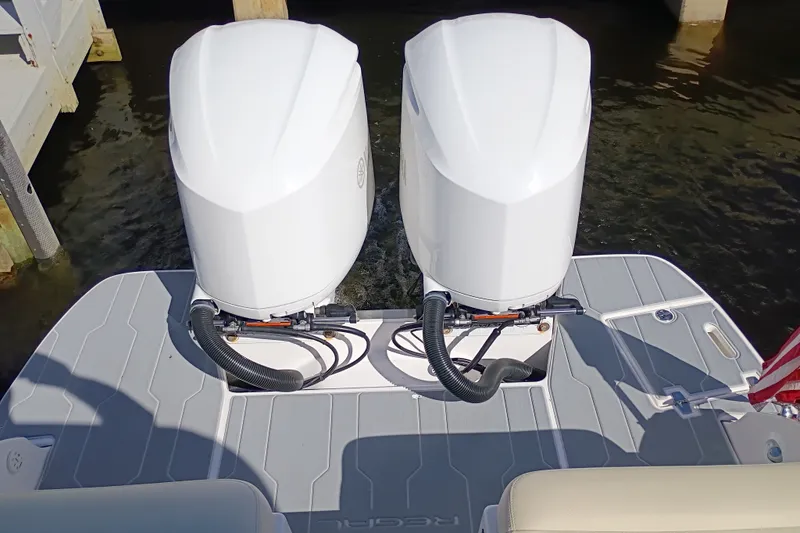 Slide: The Image of 2021 Regal 29 OBX boat with dual outboard engines on a sunny day. - 34