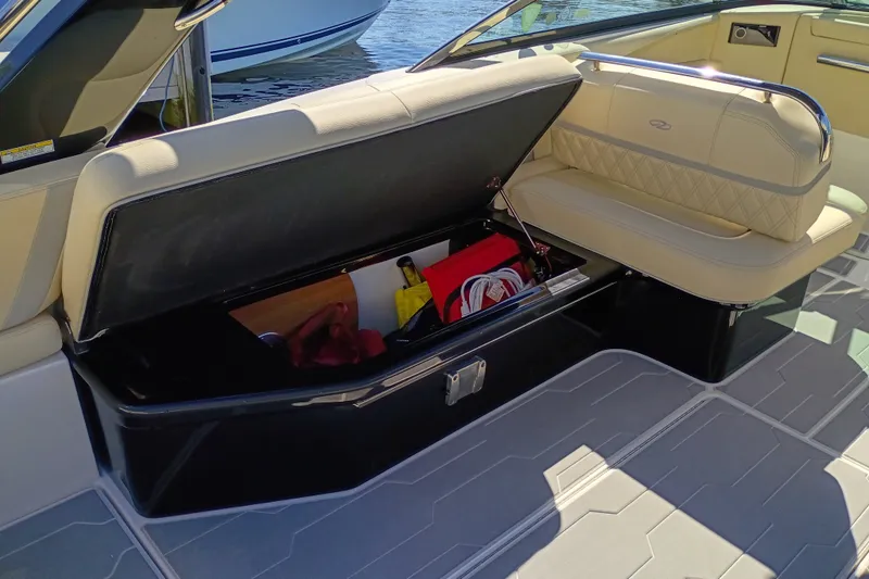 Slide: The Image of Open storage compartment in 2021 Regal 29 OBX boat with beige seating. - 41