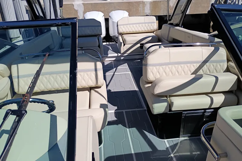 Slide: The Image of Luxurious interior of a 2021 Regal 29 OBX boat with beige seating and sleek design. - 24