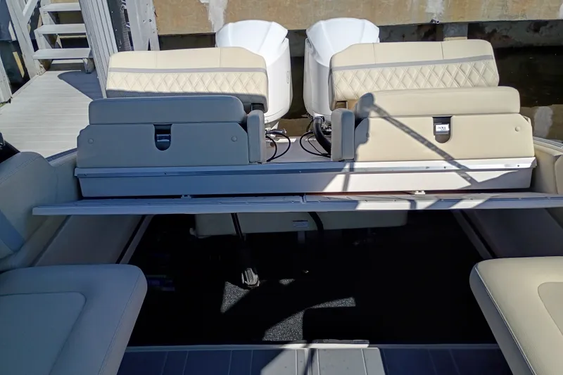 Slide: The Image of 2021 Regal 29 OBX boat interior with beige seating and dual outboard engines. - 29