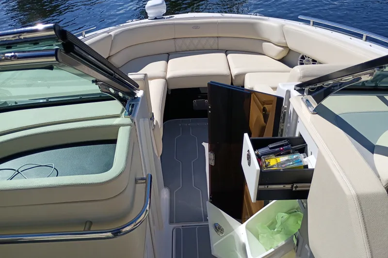 Slide: The Image of 2021 Regal 29 OBX boat interior with open storage compartments and seating area. - 43