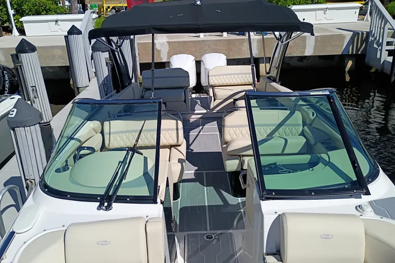 Slide: The Image of 2021 Regal 29 OBX boat docked, featuring spacious seating and sleek design. - 23