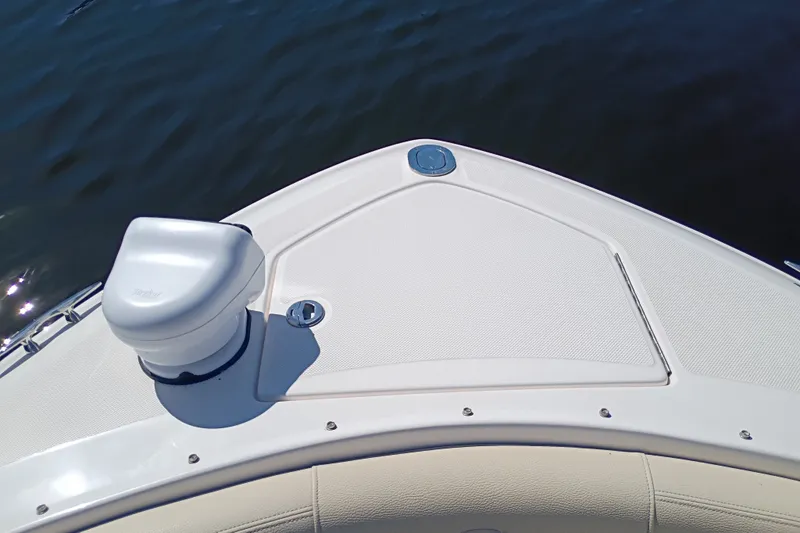 Slide: The Image of Bow of 2021 Regal 29 OBX boat with anchor compartment, on calm water. - 16